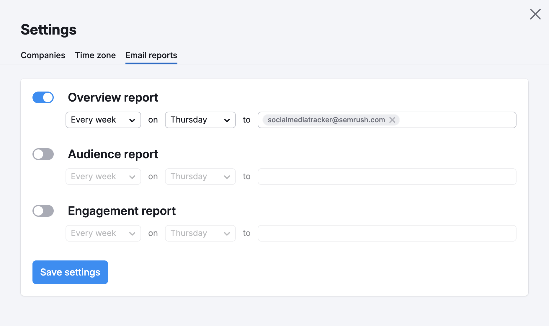 Email reports tab of the Settings menu of Social Tracker. There are three toggleable options: Overview report, Audience report, and Engagement report. Each report type has selectable frequency, day, and an email address field.